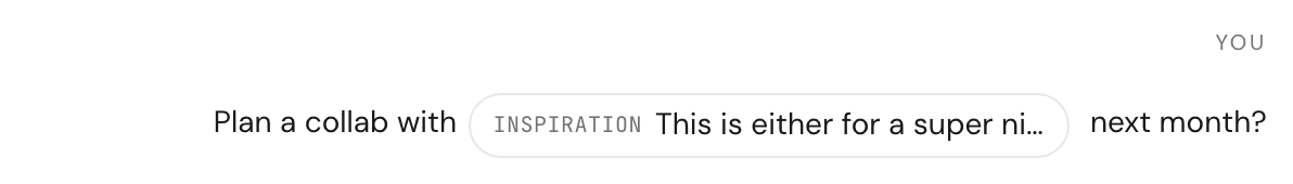 A sent chat message showing an inline @-mention chip for a brand